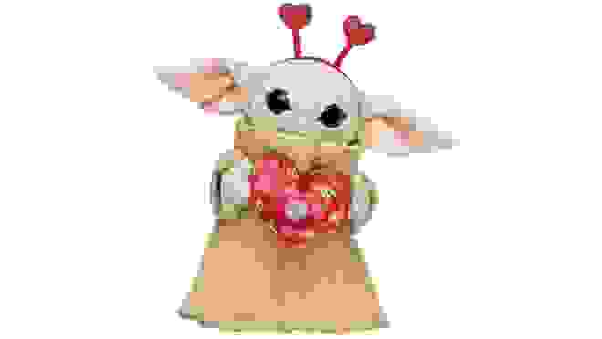 Valentine's Day themed Baby Yoda stuffed animal holding heart.