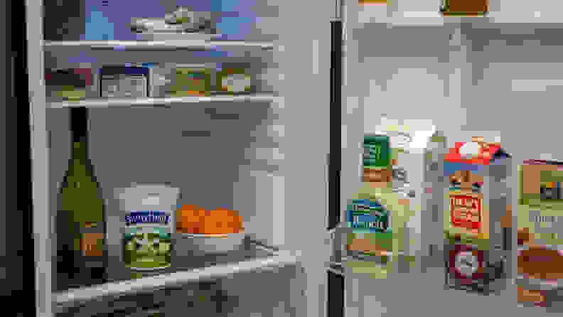 A shot of the interior of the fridge, all its shelves and bins stocked with colorful food.
