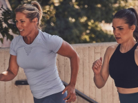 Two women running up stairs as part of a workout.