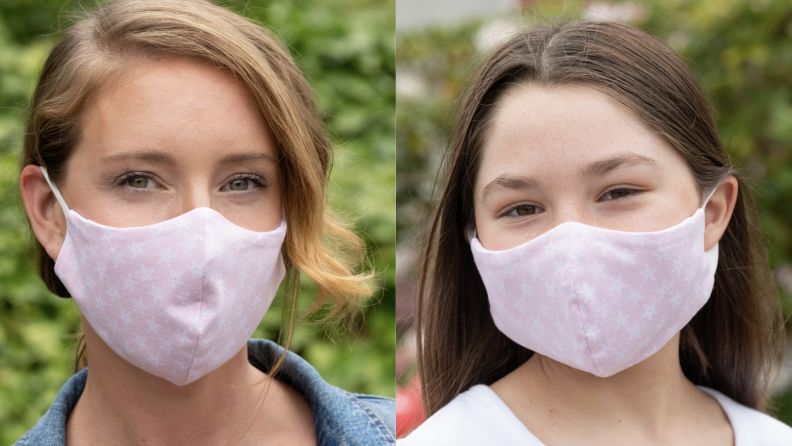 A woman and a child wearing matching light pink face masks.