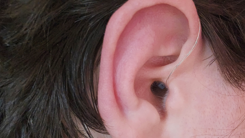 Jabra Enhance Select 500 hearing aids inserted into a tester's ear.