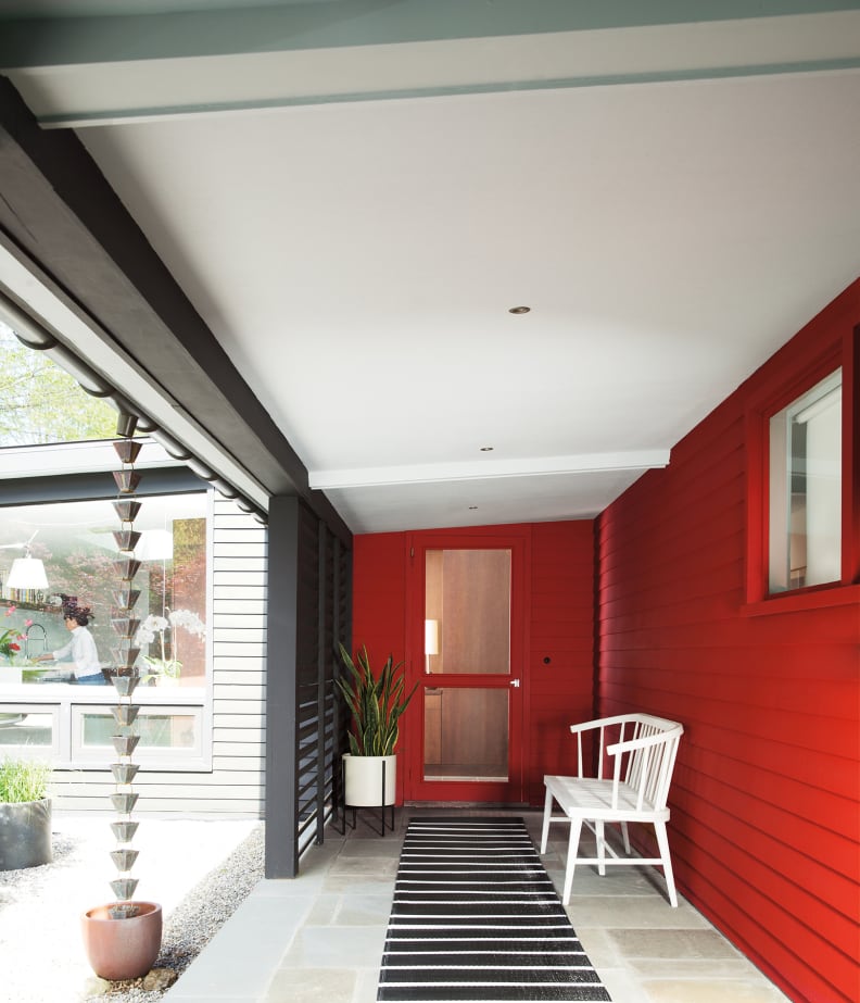 A red accent wall enlivens a space