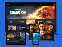 An image of several devices with the Disney+ app pulled up, including a television, a tablet, a phone, and a laptop. The various screens display the Disney+ catalog, including the promotional images for the series _Loki_ and the films _Shang Chi_ and _Black Panther_.