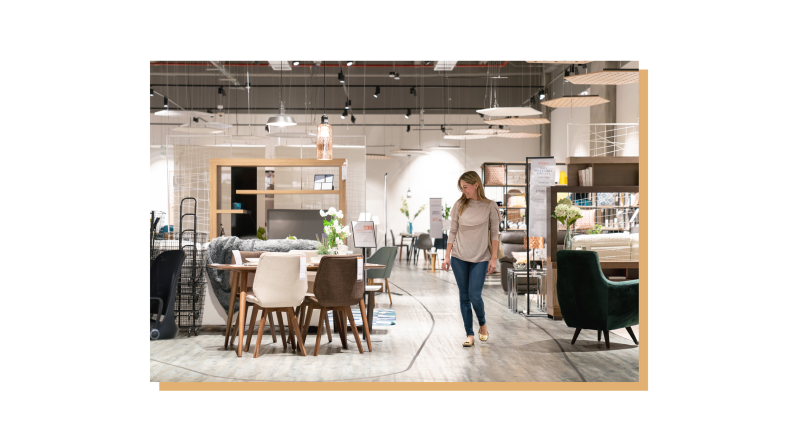 Customer walking around furniture store while shopping.