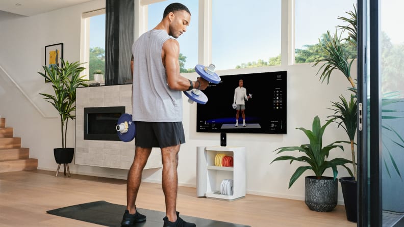 A man doing bicep curls with the Tempo Move dumbbells.