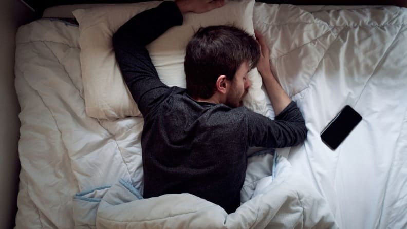 someone sleeps beside their phone