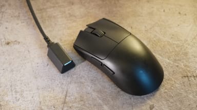 The Razer Viper V3 Pro, a black symmetrical mouse and the USB-C hyperpolling dongle
