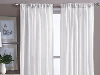 White curtains in front of window in room.