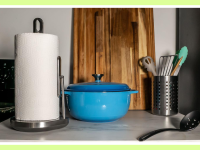 The Simplehuman paper towel pump on a counter with a dutch oven