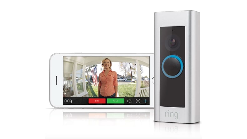 Phone with live stream of front door next to Ring security bell.