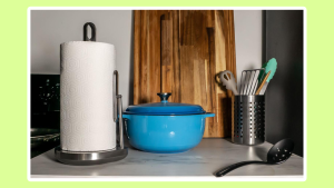 The Simplehuman paper towel pump on a counter with a dutch oven