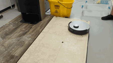 The Ecovacs Deebot X1 Omni cleaning chocolate syrup off linoleum floors