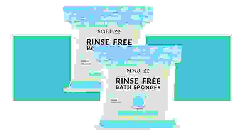 Two packets of Scrubzz Disposable No Rinse Bathing Wipes in front of a background.