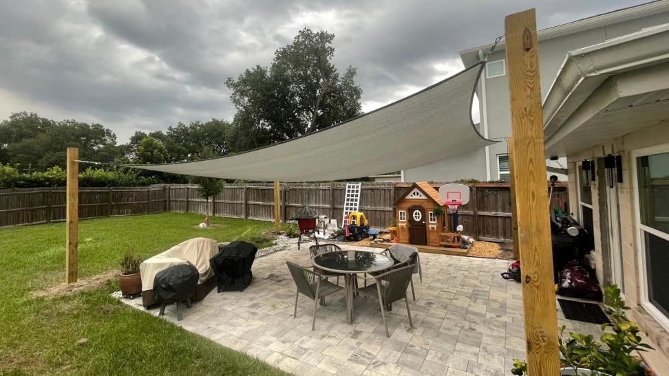 A home with a shade sail installed in the backyard.