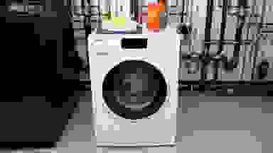 The Miele WWD660WCS Washing Machine in the Reviewed Labs with a box of Tide pods on top.