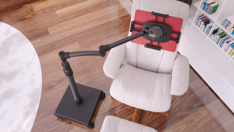 Tablet stand hanging over arm chair and foot rest