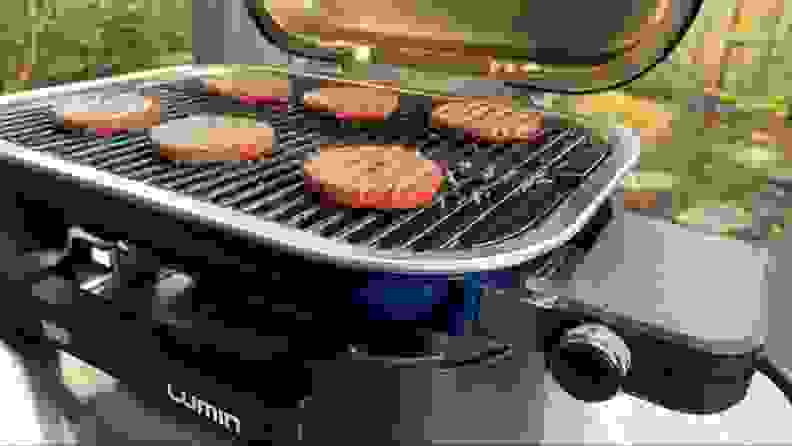 Burger patties being grilled on the Weber Lumin.