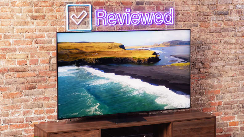 The 65-inch Samsung QN90C Neo QLED TV in a living room setting displaying a 4K image of a shoreline