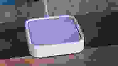 The Samsung SmartThings Station plugged in and sitting atop a table.