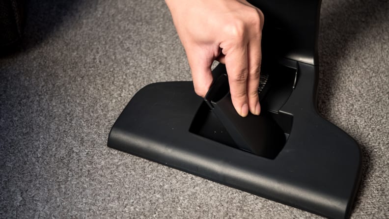 The crevice and dust brush are stored on the charging cradle.