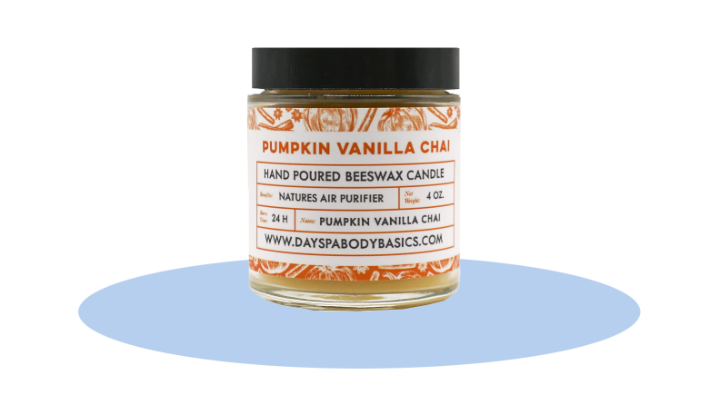 The Nature’s Apothecary Pumpkin Vanilla Chai Candle in front of a background.