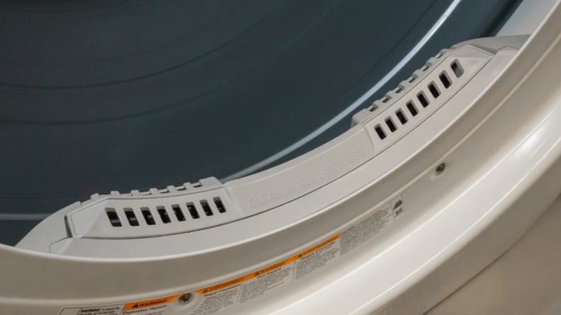 The shot of a dryer's drum, highlighting its internal lint trap.