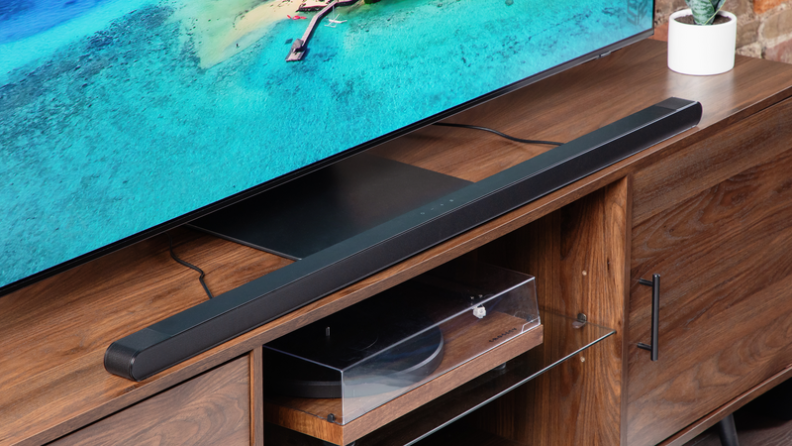 Close-up of the soundbar beneath a flatscreen.