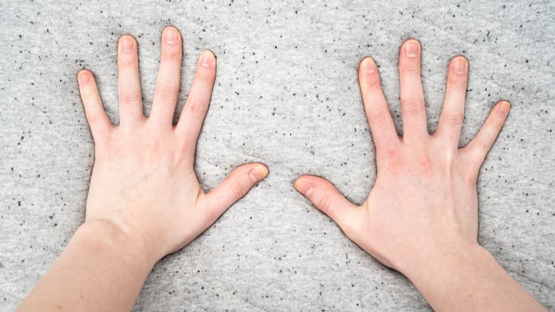 hands pressing into foam mattress