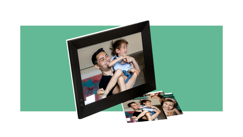 Digital picture frame with parent and child smiling together inside the black frame next to physical copies of the photo itself.