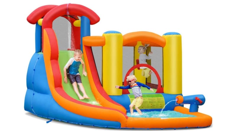 Kids jumping and swimming in a bounce house with a wading pool