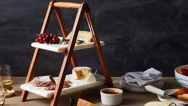 A meal is displayed on a wooden tier server.