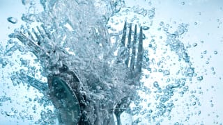 Cutlery in water surrounded by bubbles