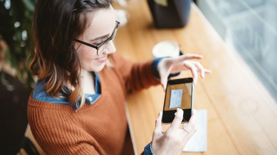 Woman depositing a check with online bank mobile app