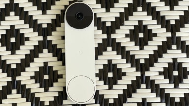The Nest Doorbell (battery) on a black and white chair.