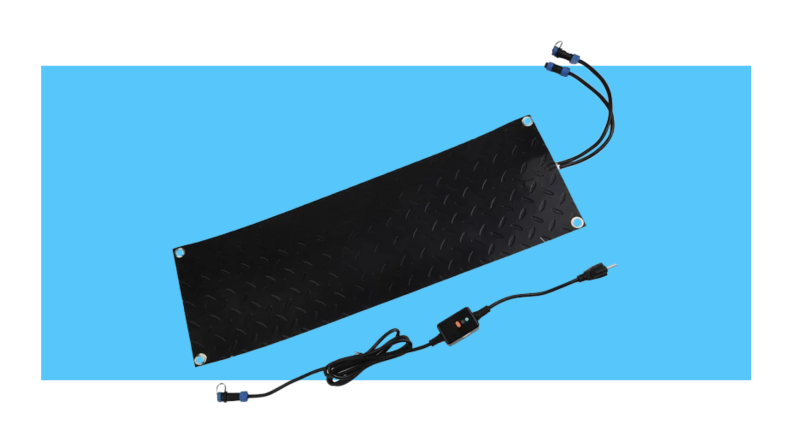 Three identical, black snow melting mats with power cords sticking out the bottom in front of blue background.