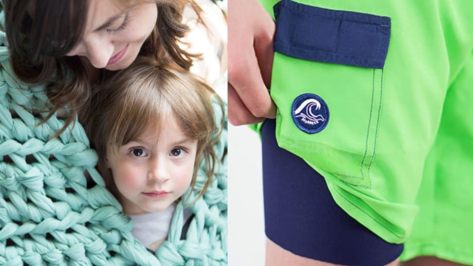 A mother and daughter cuddle, wrapped in a mint-green weighted blanket. A pair of green swim trunks; a child's hand shows a smooth inner liner in navy blue.