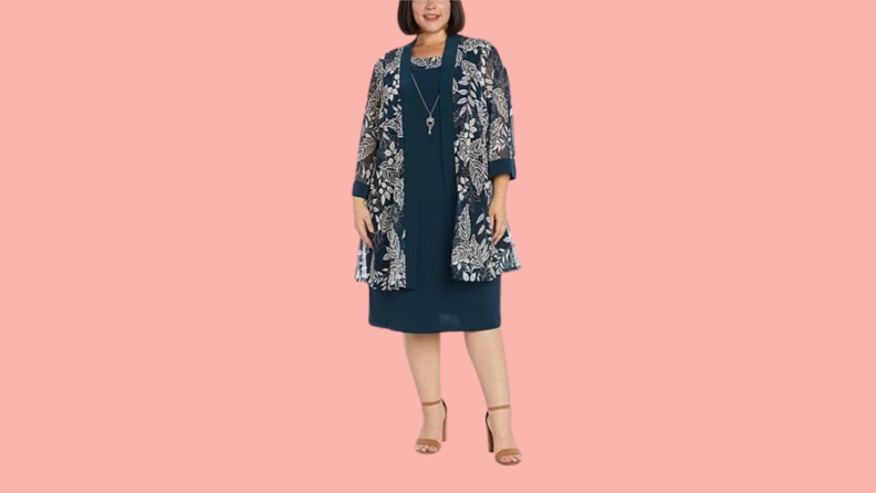 A model wearing a navy shift dress with coordinating printed jacket.