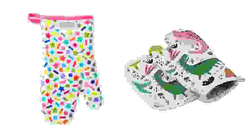 A pair of oven mitts features colorful, kid-friendly designs: stars, shapes, dinosaurs, and so on.
