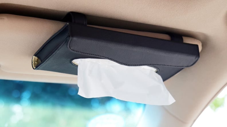 Tissue holder on dashboard in a car.