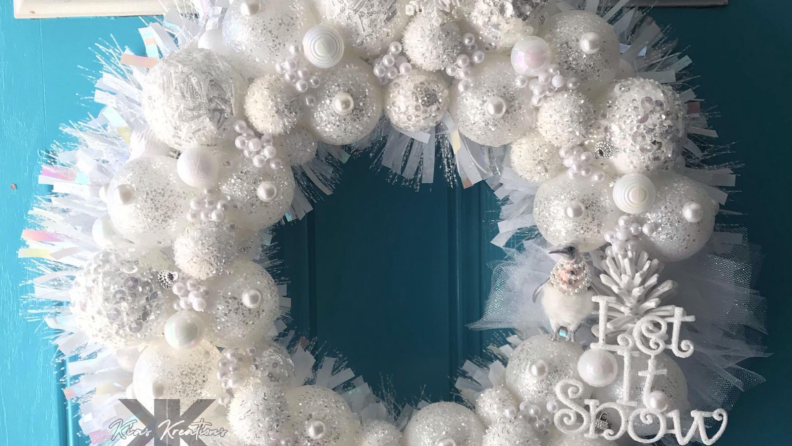 Homemade white ornament wreath on a blue door