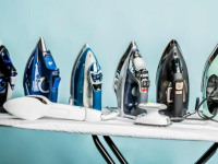 A line of steam irons on an ironing board on a blue background