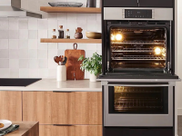 Bosch stacked oven in modern-style kitchen, with top oven open.