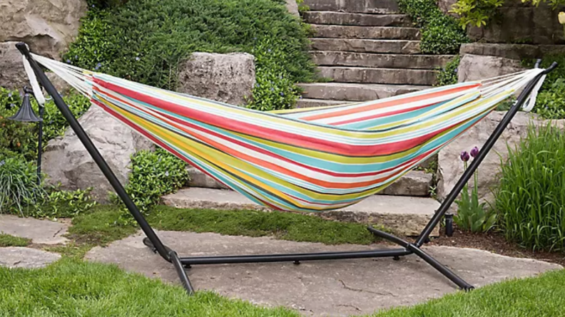This colorful hammock comes with a metal stand.