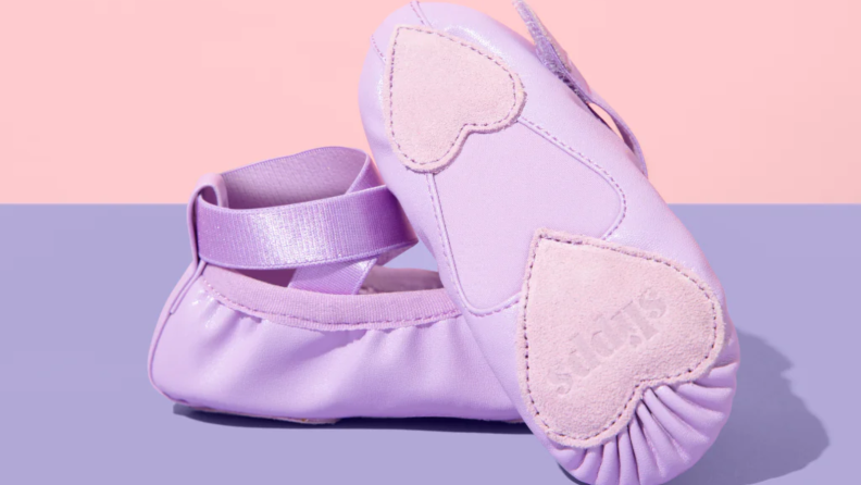 Purple Slipps ballet slippers on a pink background