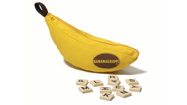 An image of the game Bananagrams in its banana-shaped bag with several letter tiles strewn across the foreground.