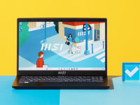 The MSI Modern 15 (2023) in black on a blue and yellow background next to a Reviewed checkmark.