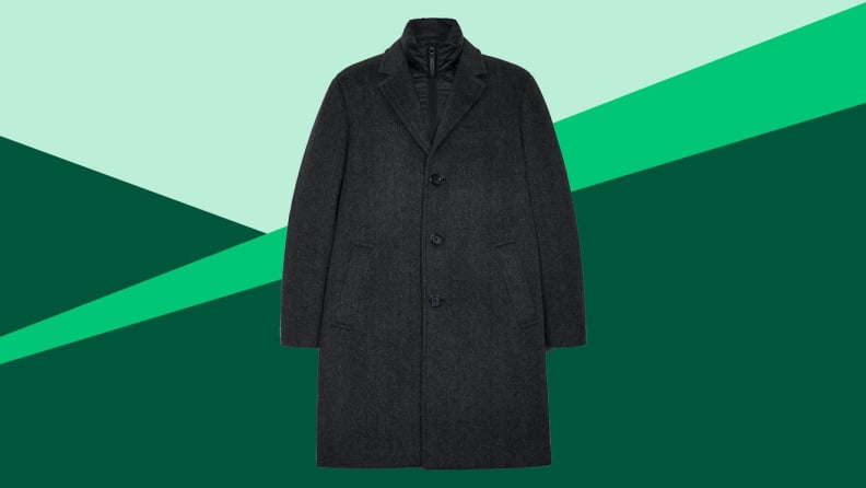 A black overcoat against a green background.