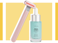 Red light therapy wand next to bottle of skin serum.