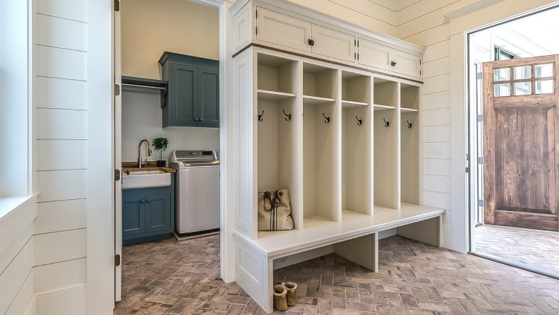 A dedicated mudroom can handle a wall of cabinets, cubbies, and hooks, and maybe even a bench where you can sit to take off your shoes.