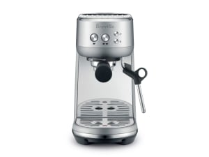 Breville Bambino espresso maker on brown paper-like background